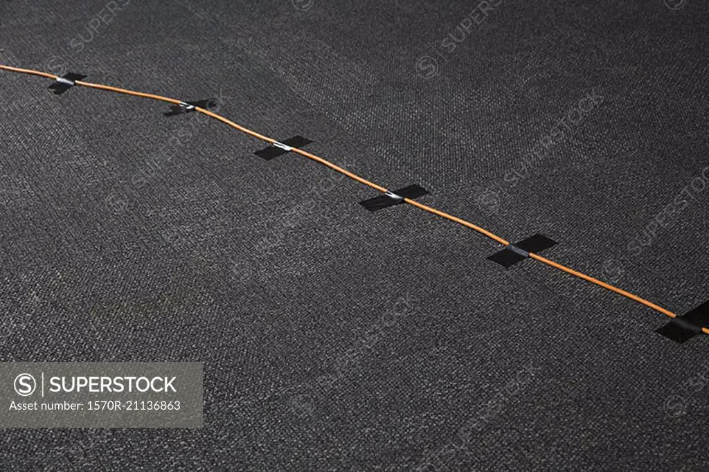 High angle view of cables attached on black carpet