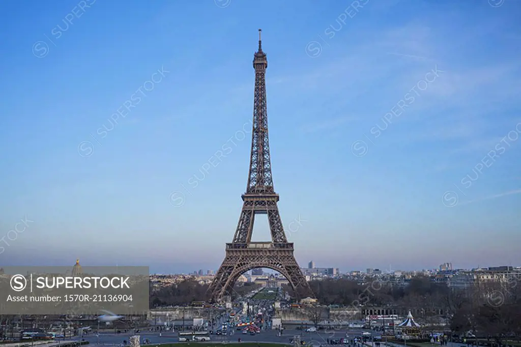 Eiffel tower in city against blue sky