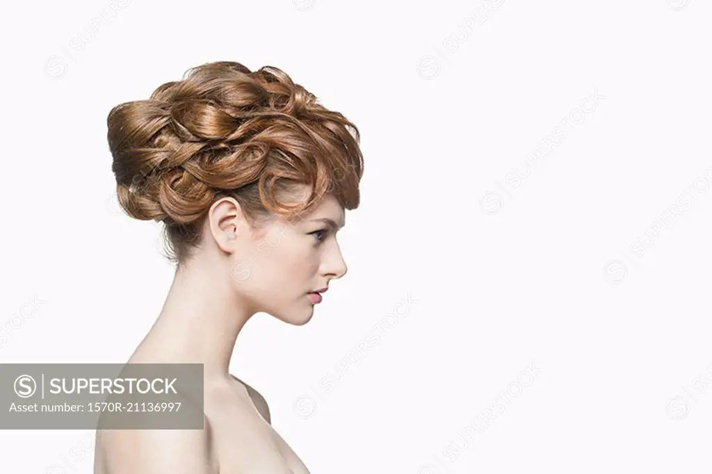 Side view of beautiful woman with hairstyle against white background