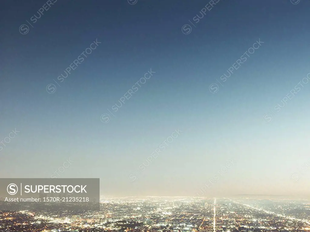 Aerial view of illuminated cityscape against blue sky, Los Angeles, California, USA