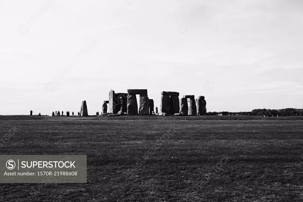View of Stonehenge in mid distance against sky, Wiltshire, United Kingdom