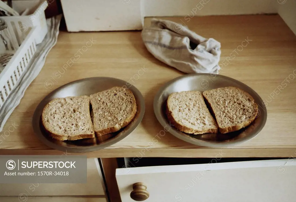 Slices of bread on plates on a counter