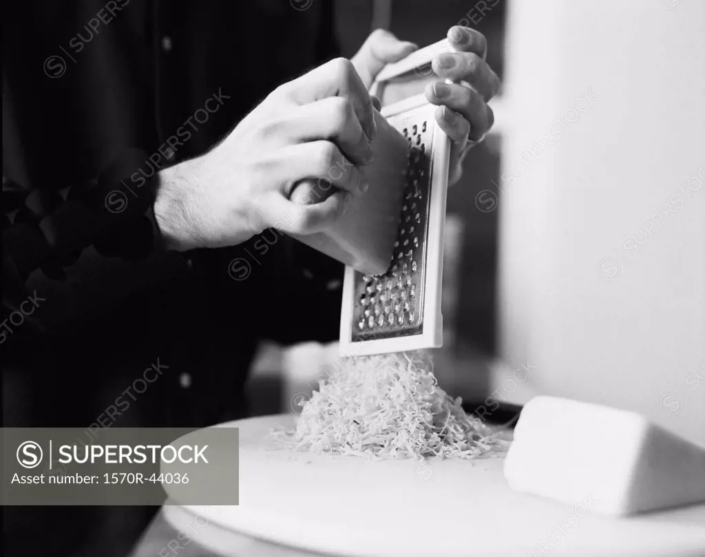 A person grating cheese
