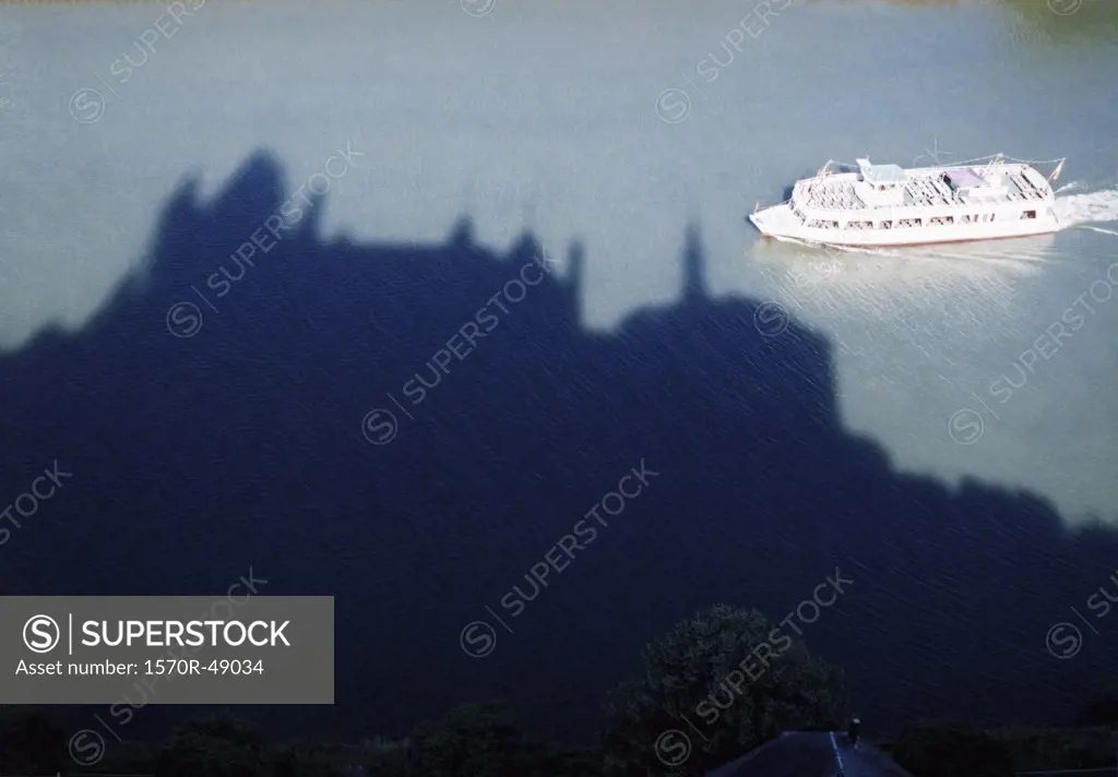 boat crossing the shadow of a castle