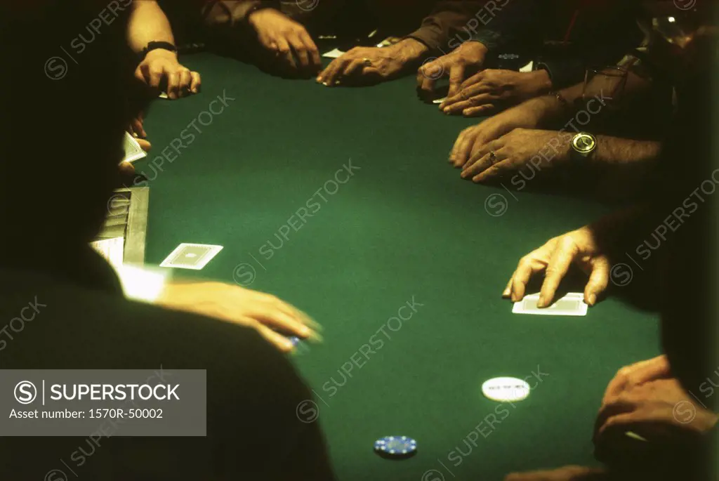 group of people gambling at a casino blackjack table