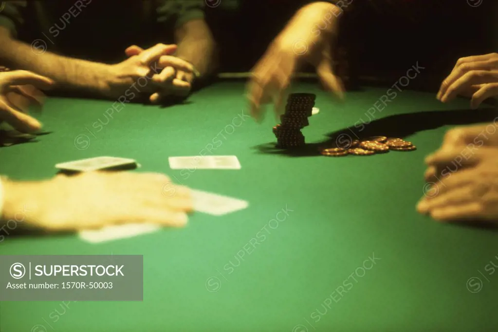 group of people gambling at a casino blackjack table