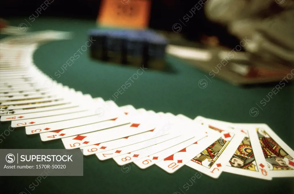 Playing cards spread out across a casino table
