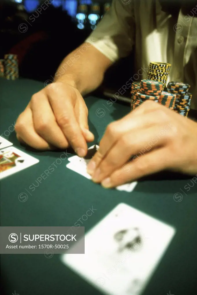 Detail of a man playing blackjack at a casino