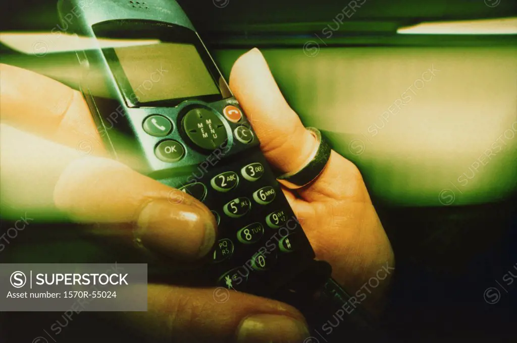 A hand holding a cell phone