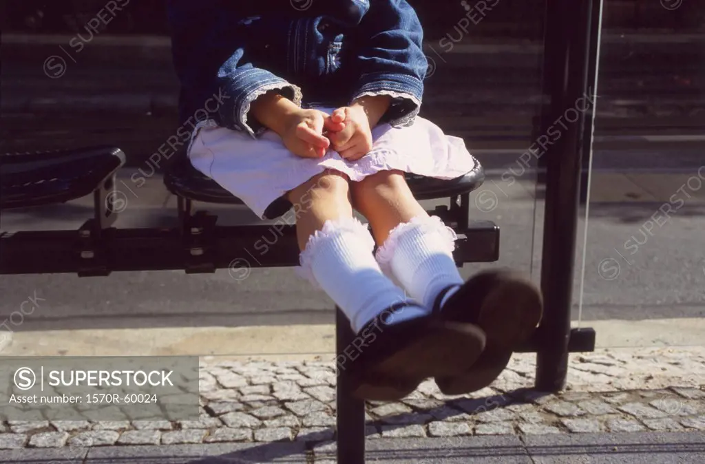 A girl sitting on a bench
