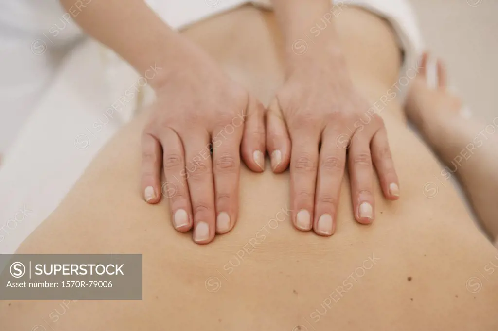 A massage therapist massaging a back 