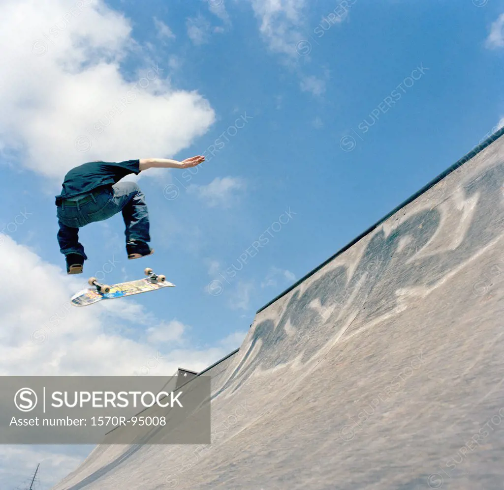 Man jumping in air with skateboard