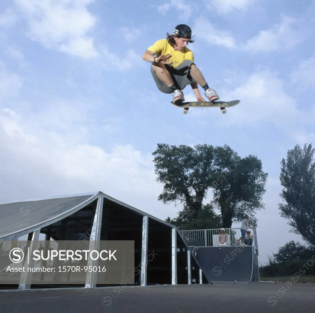 Man on skateboard jumping, mid-air