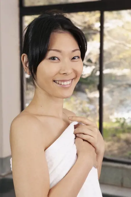 Portrait beautiful young woman in bathrobe at spa