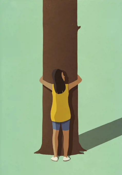 Environmentalist woman hugging tree trunk
