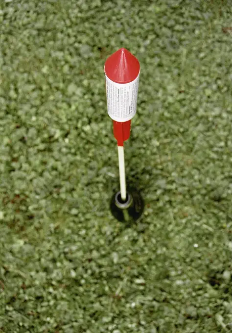 Bottle rocket aimed for launch on grass