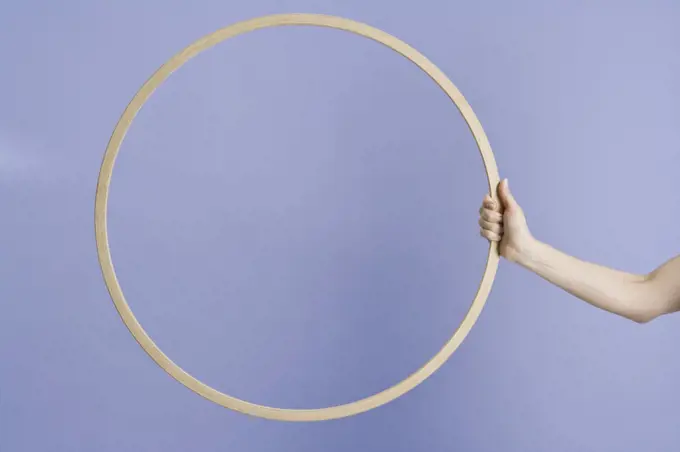 A woman holding a plastic hoop