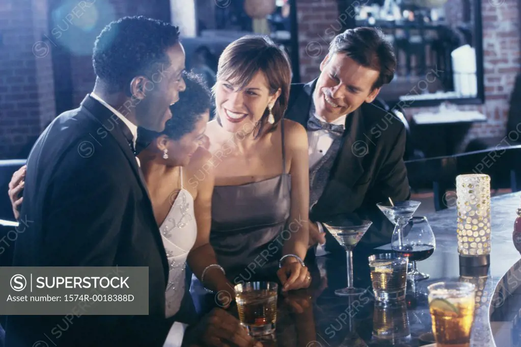 Two young couples together in a bar