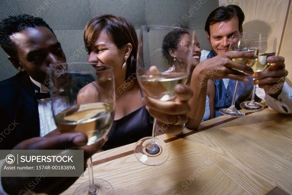 High angle view of two young couples toasting with wineglasses