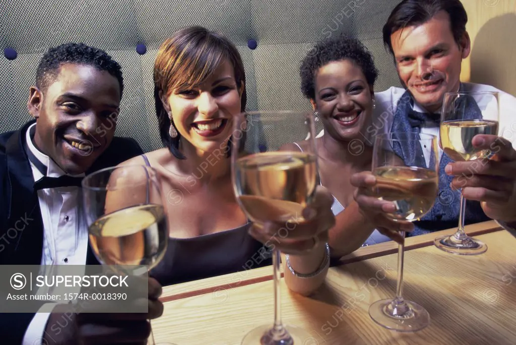 Portrait of two young couples toasting with wineglasses