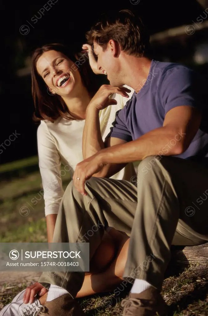 Young couple sitting together and laughing