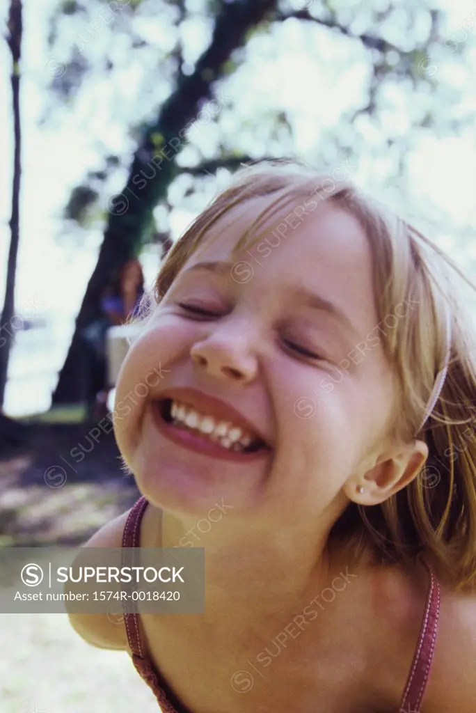 Close-up of a girl smiling with her eyes closed