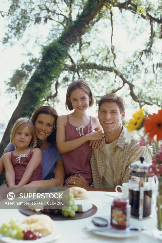 Portrait of parents with their two daughters smiling