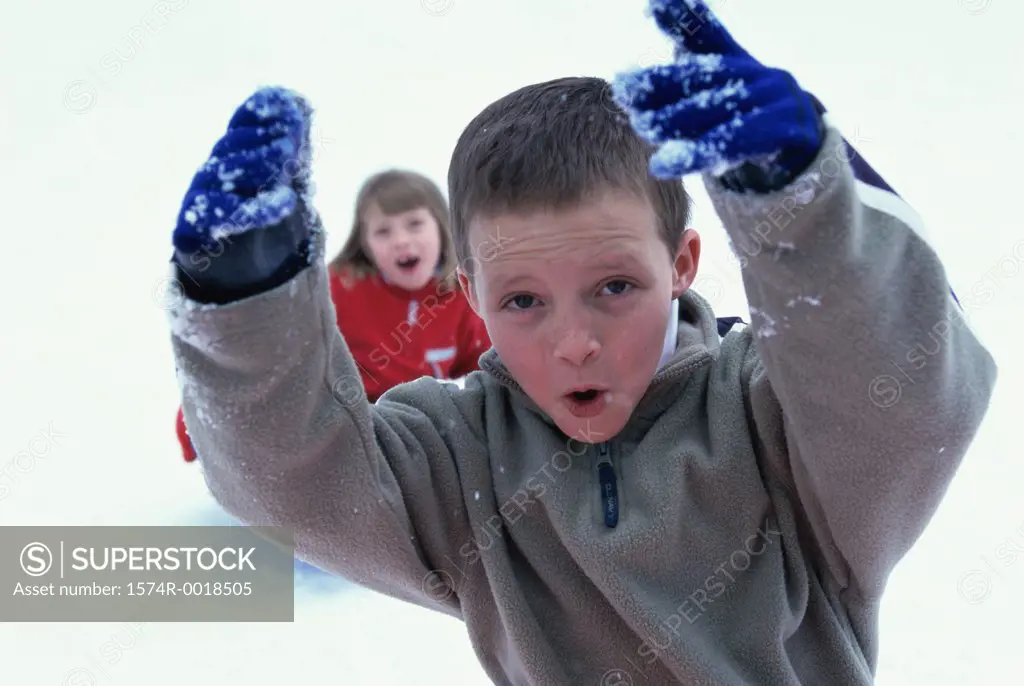 Close-up of a boy playing with snow