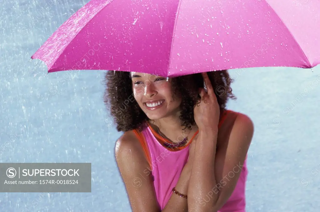 Young woman holding an umbrella in the rain