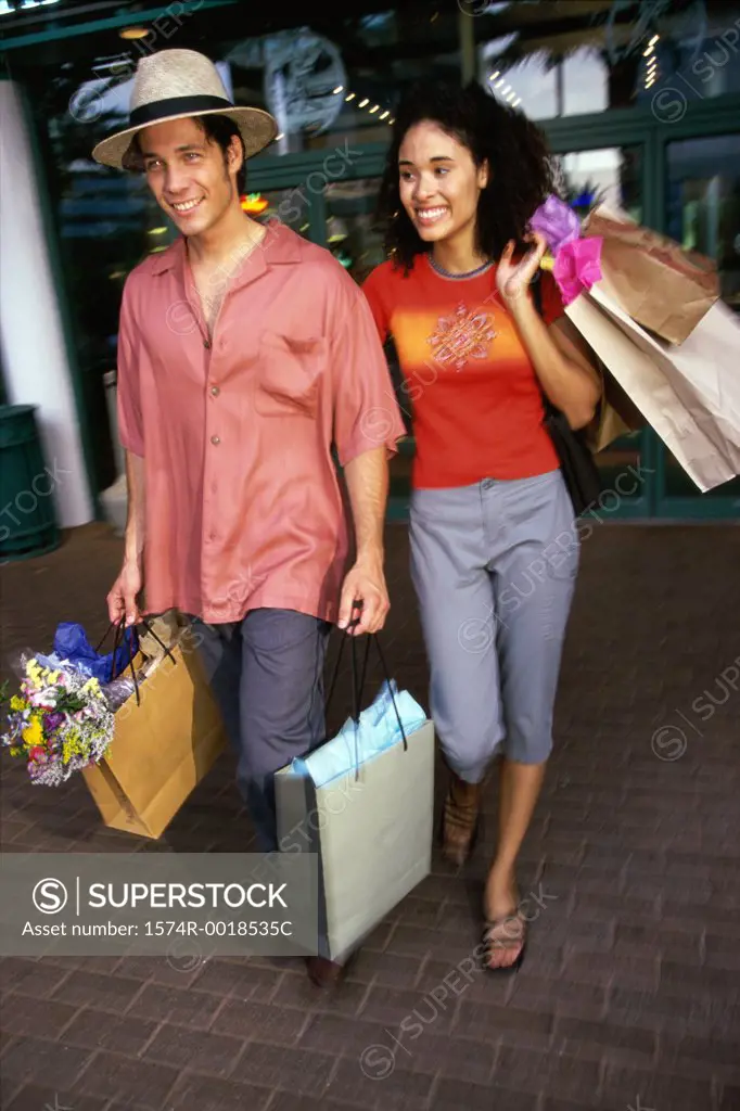 Young couple carrying shopping bags