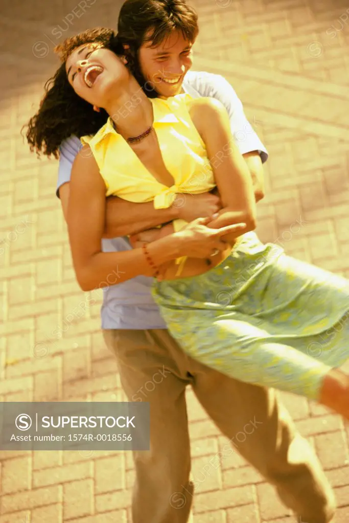 High angle view of a young man lifting a young woman