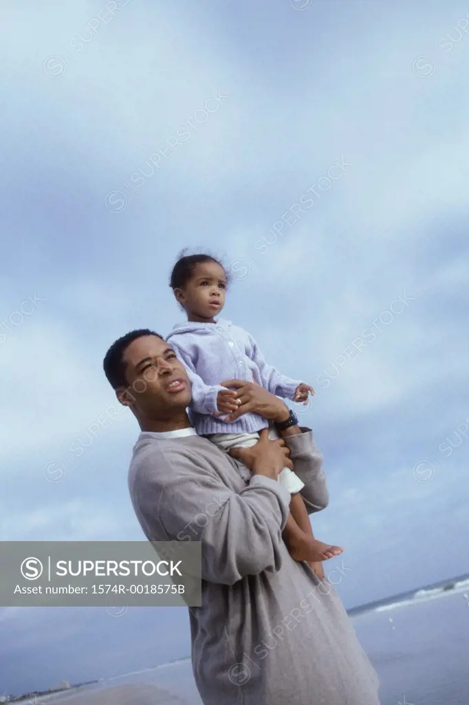 Side profile of a father carrying his daughter on his shoulders