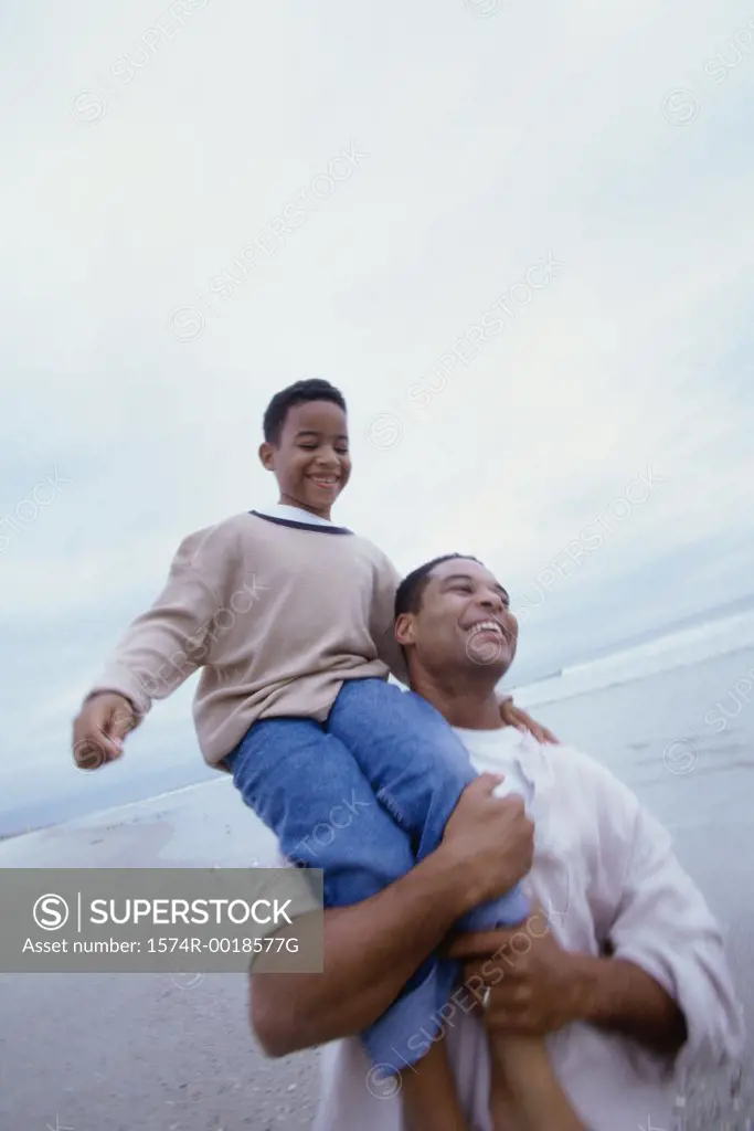 Father carrying his son on his shoulders