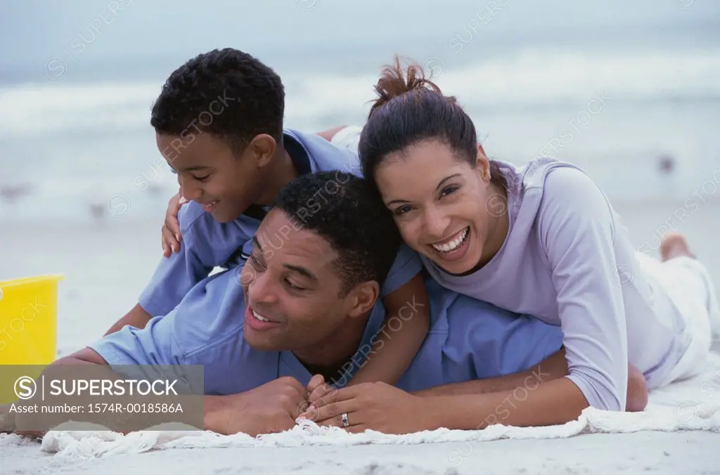 Close-up of parents and their son smiling on the beach