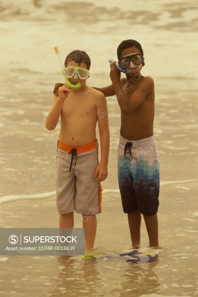 Portrait of two boys wearing snorkel masks on the beach