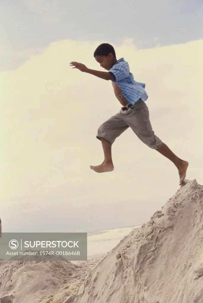 Side view of a boy jumping on the beach