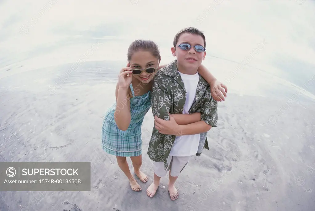 Portrait of a boy and a girl wearing sunglasses