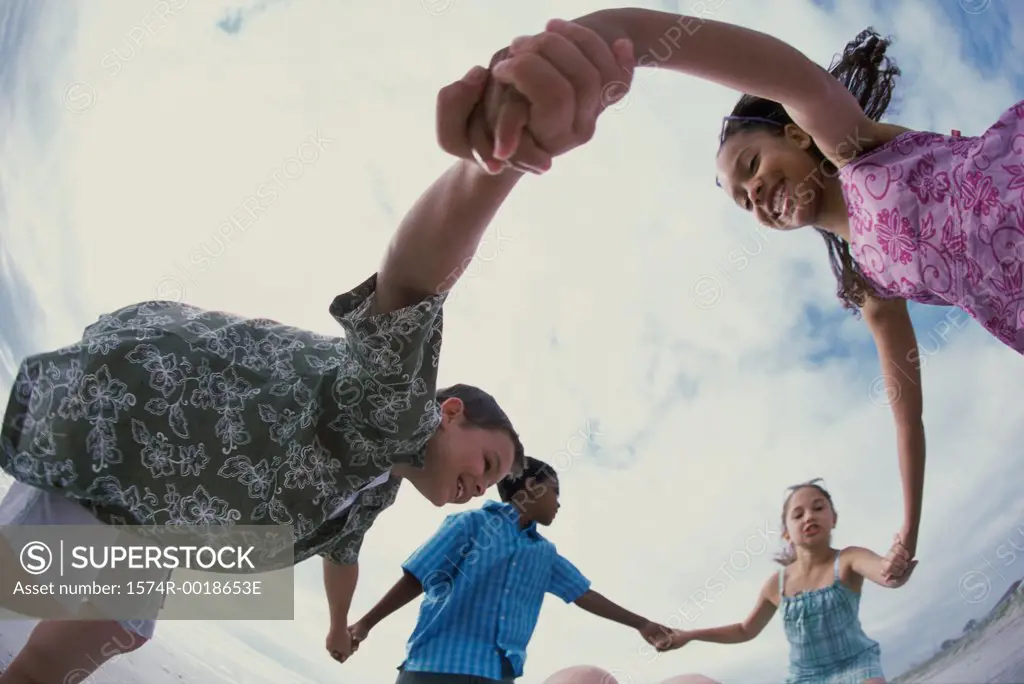 Low angle view of a group of children holding hands