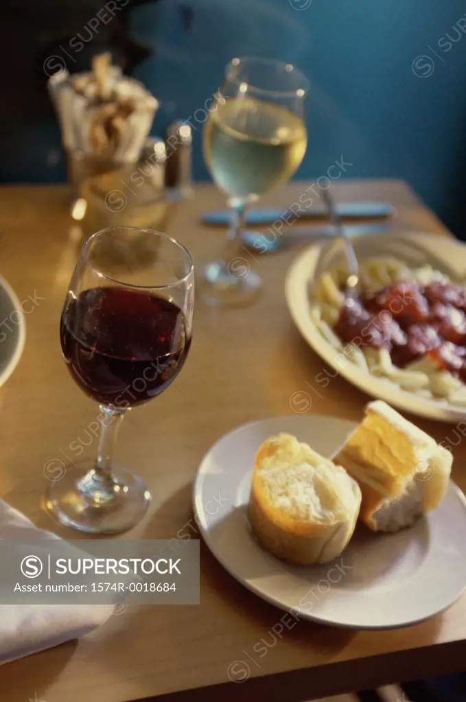 Close-up of food with two glasses of wine on a table