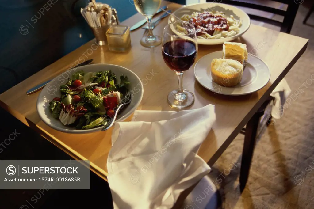 Close-up of food with two glasses of wine on a table