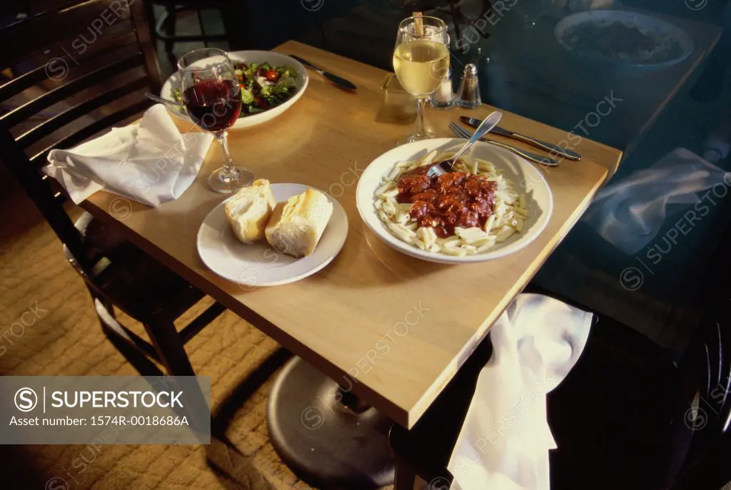 High angle view of food with two glasses of wine on a table