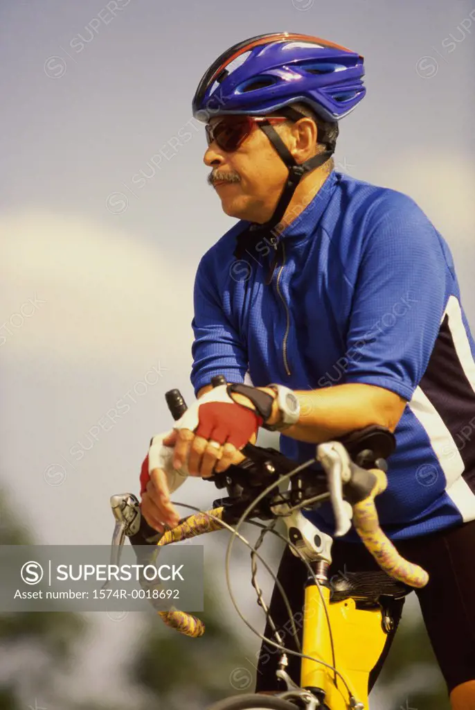 Mid adult man standing with a bicycle