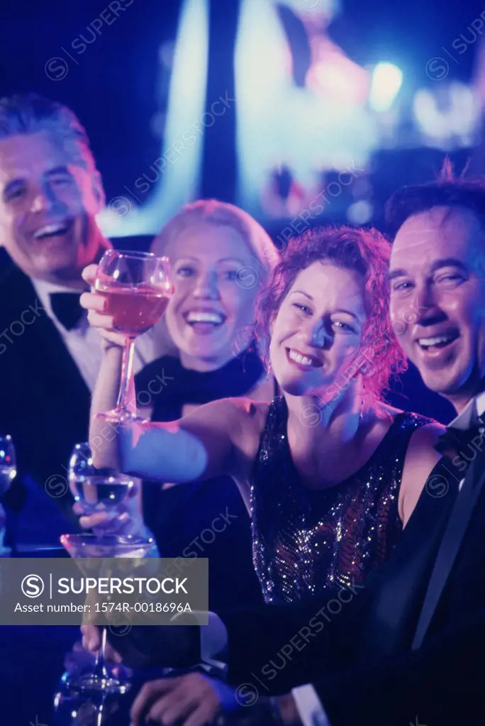 Two mature couples toasting wineglasses