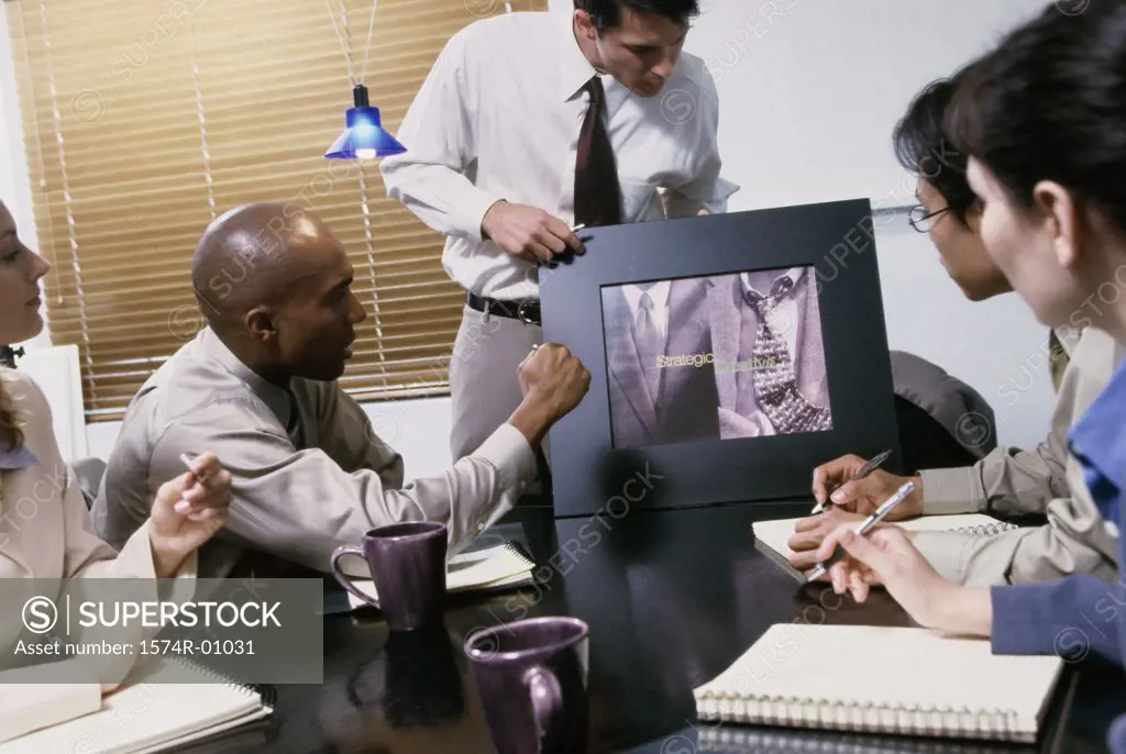 Business executives at a presentation in a conference room