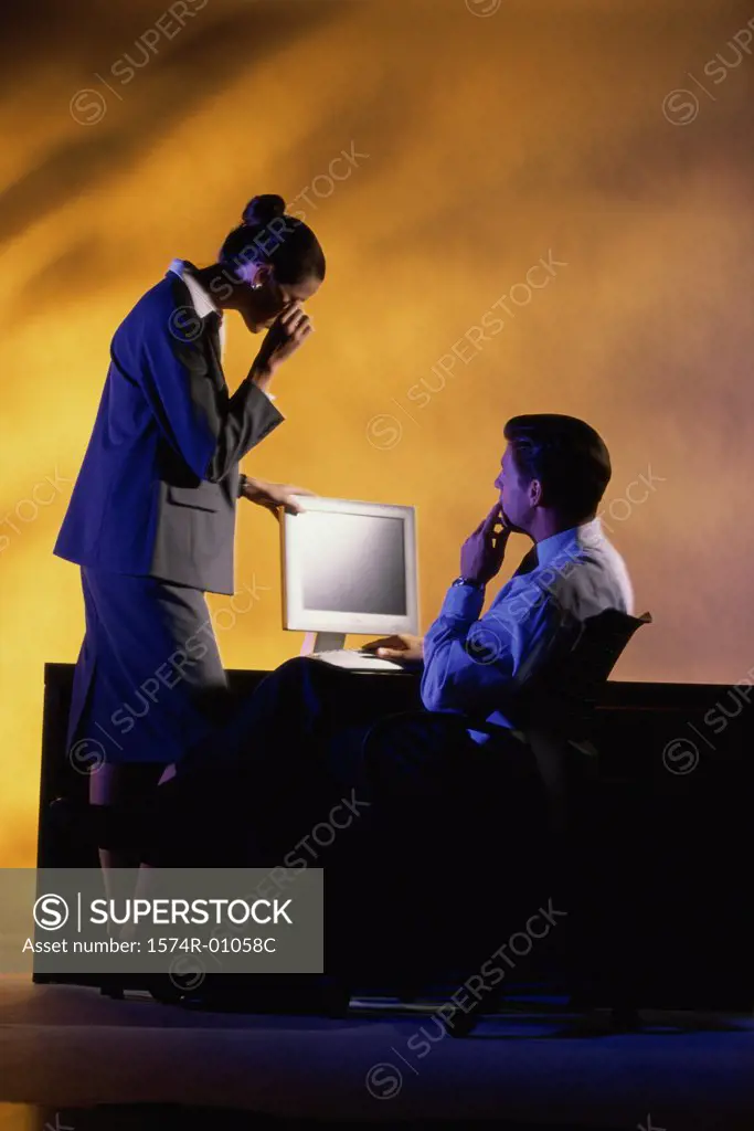 Businessman and a businesswoman using a computer