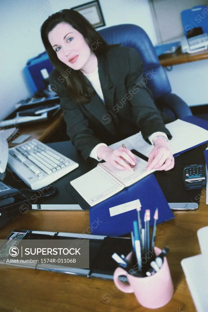 Portrait of a businesswoman seated behind a desk in an office