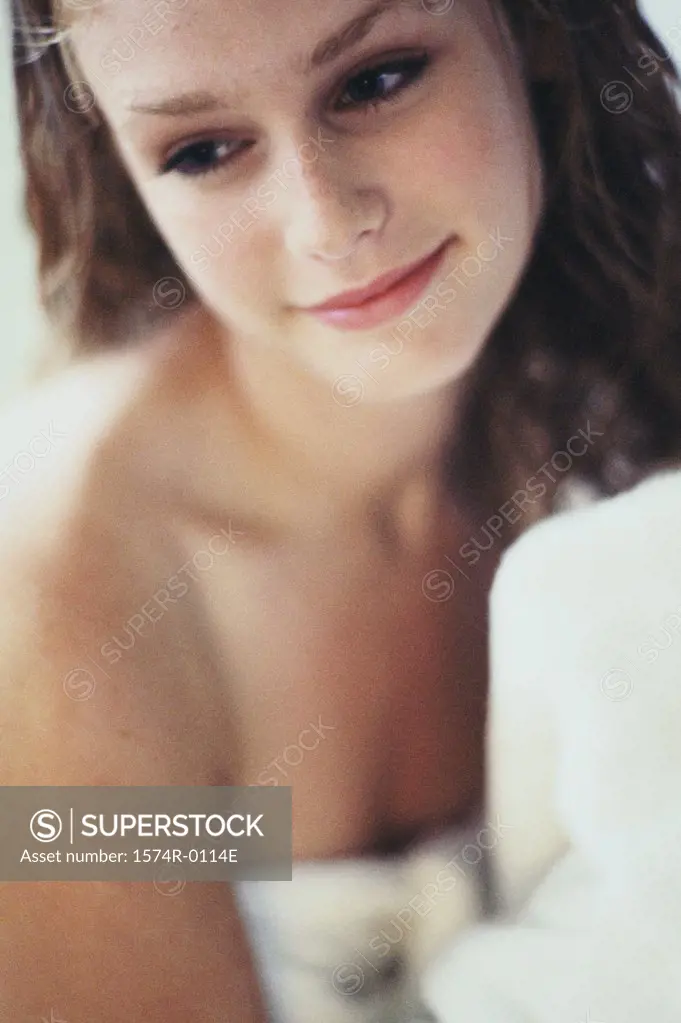 Close-up of a young woman's face and bare shoulders