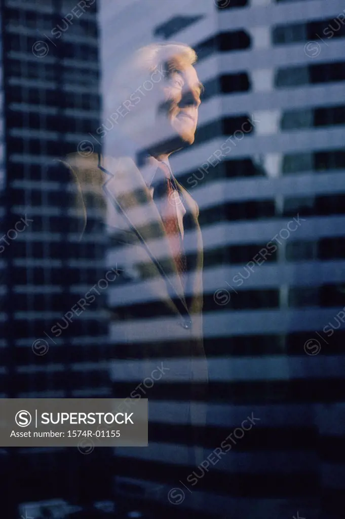 Reflection of a businessman on a window
