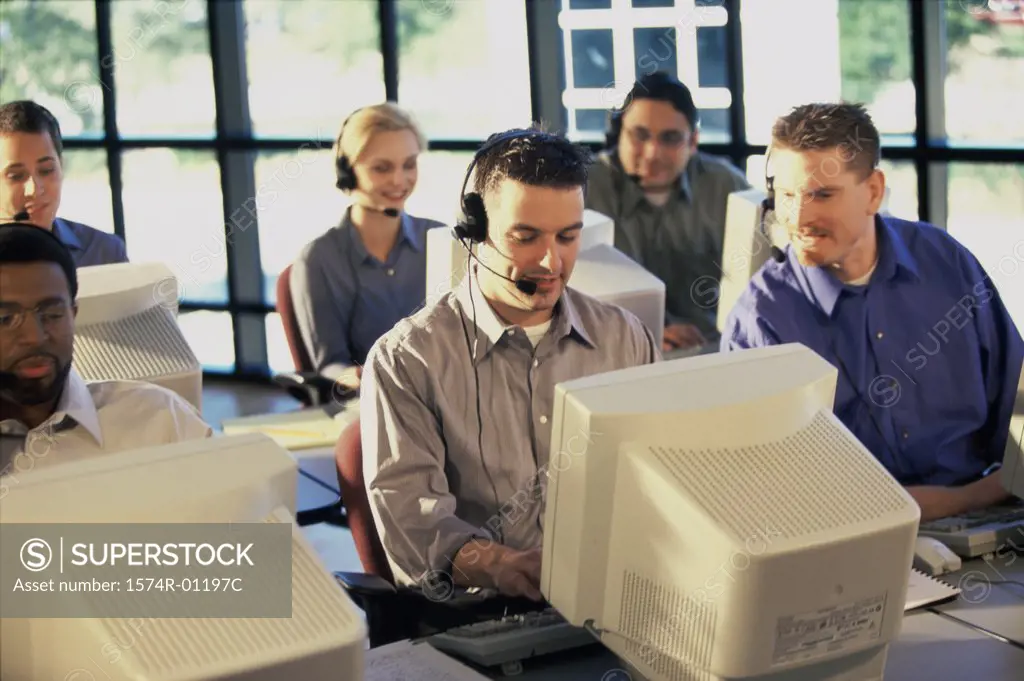 Group of business executives working on computers