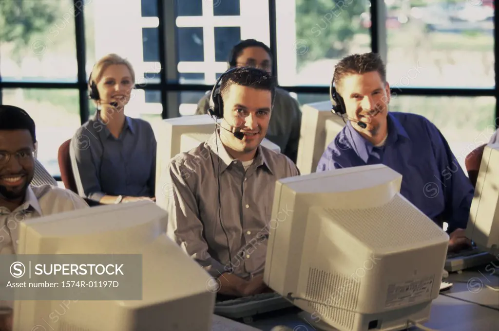 Portrait of a group of business executives working on computers